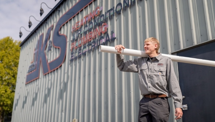 Plumber With Building And Pvc Pipe