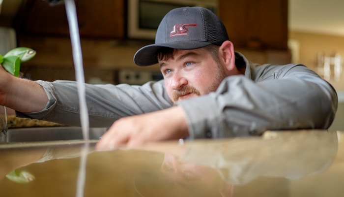 Plumber With Kitchen Faucet Running