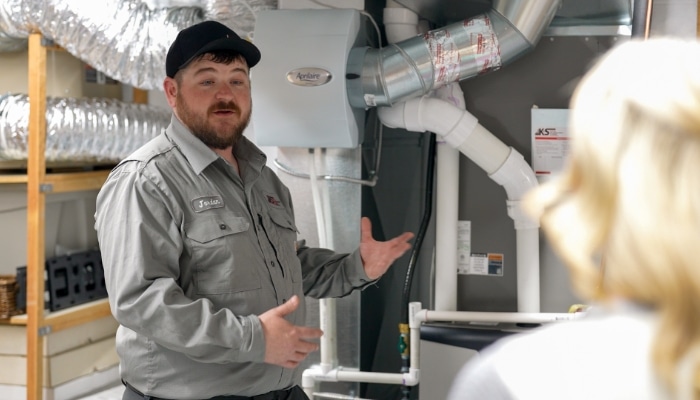 Technician And Air Handler With Customer
