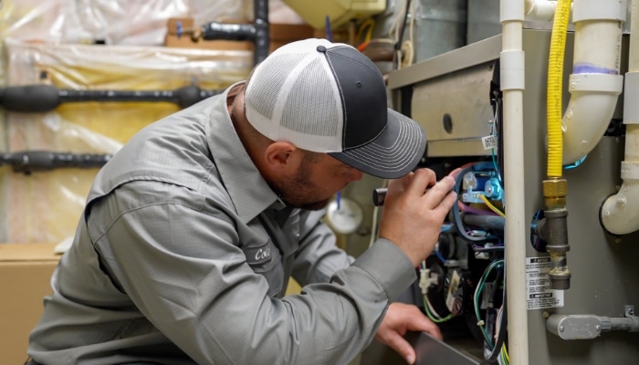 Technician Looking At Furnace